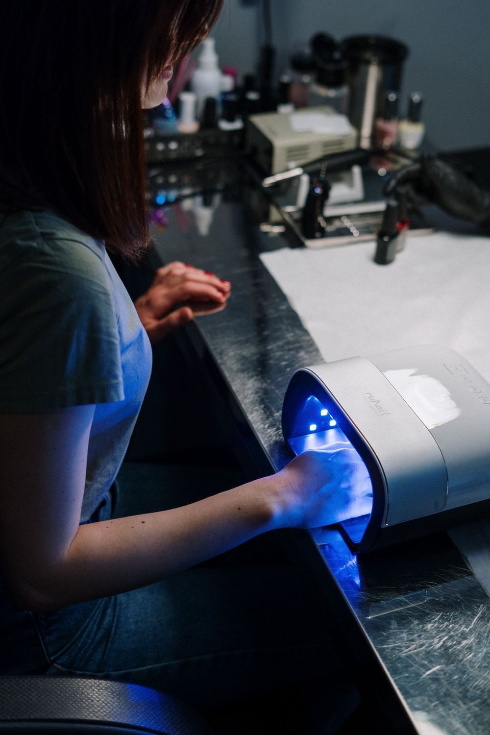 Gel manicure curing under a lamp